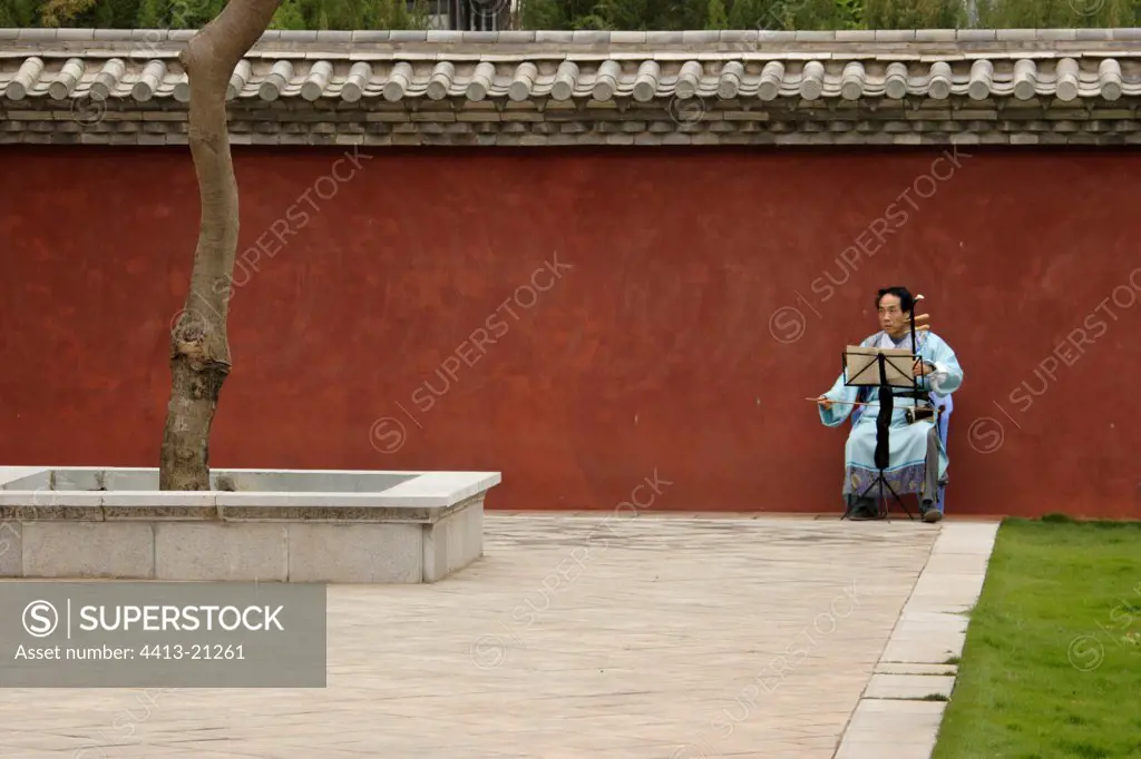 Musician in the Garden of Confucius Jianshui Yunnan China