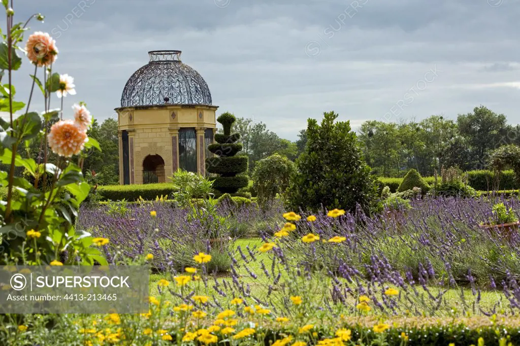 Topiaries and flower massifs around a dovecote France