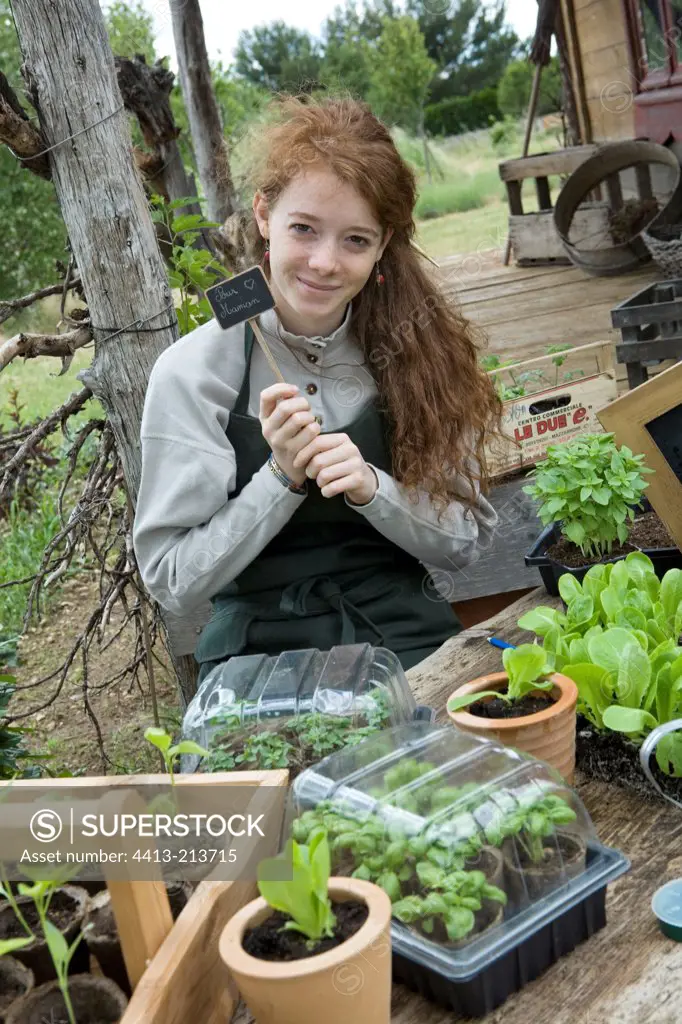 Teen girl sending a message written on a small garden slate