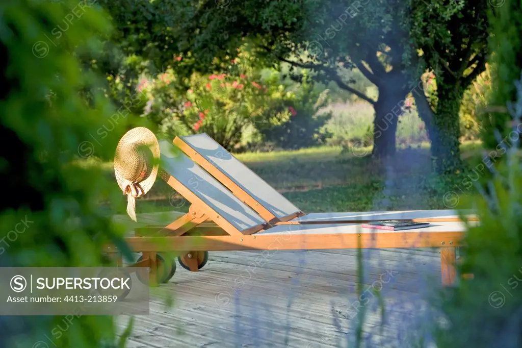 Deckchair onto a wooden terrace garden Provence