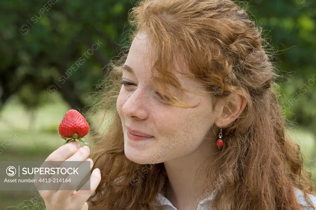 Portrait of a young girl about to eat a strawberry Provence