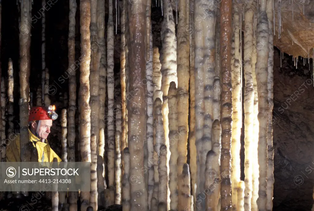 Spéléologue amid stalagmitic columns Aveyron France