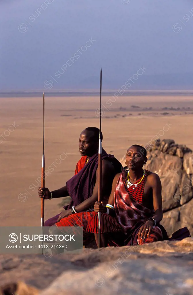 Masai warriors sit on a rock Tanzania