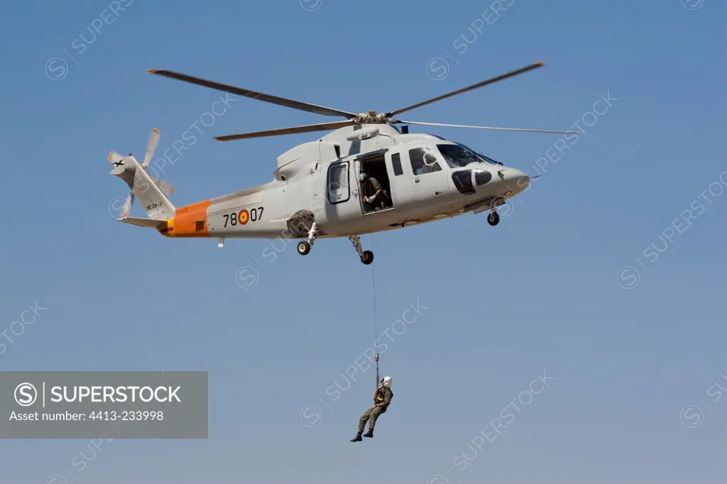 Person suspended to a helicopter hovering