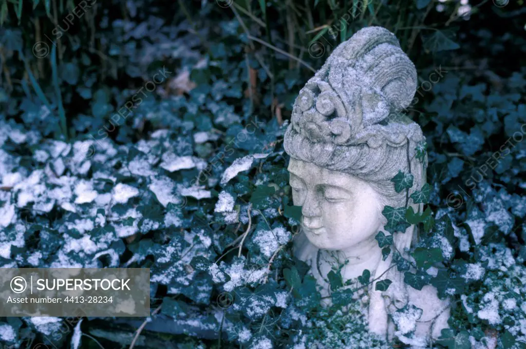 Snow-covered garden sculpture France