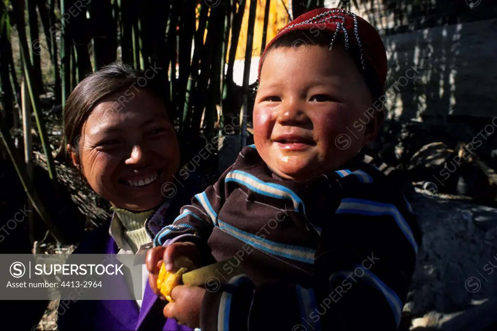 Portrait of a Naxi child and his mother Yunnan China