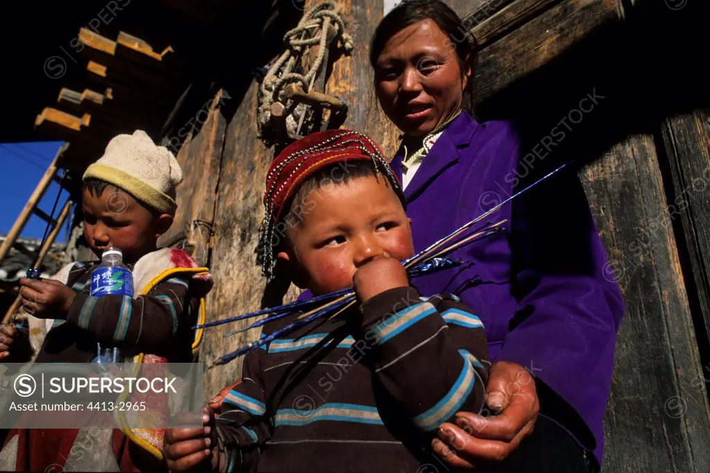 Naxi children and their mother Yunnan China