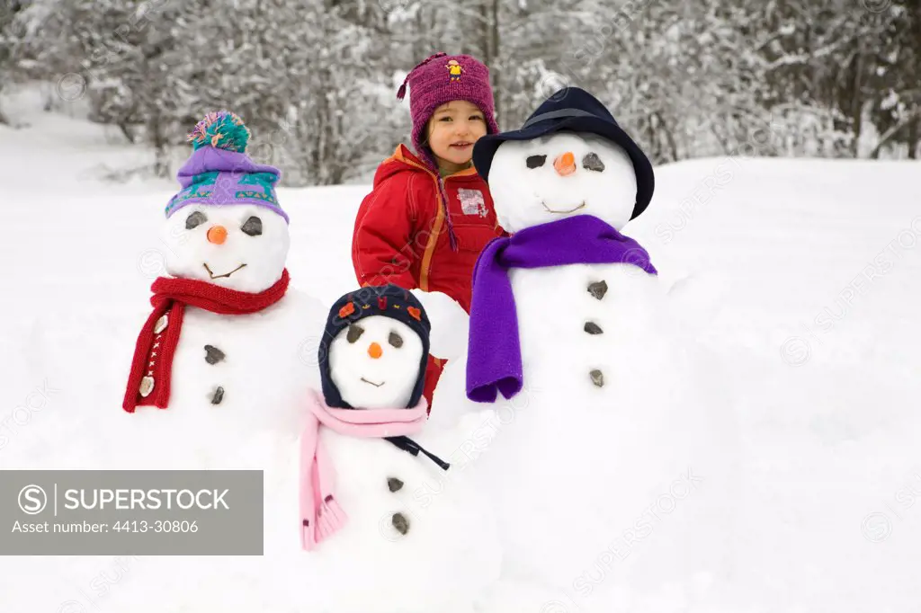 Girl in the midst of a family of snowmen