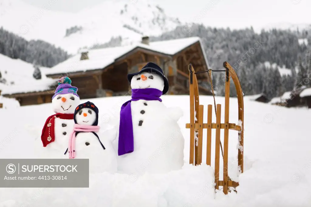 Family snowmen dressed for winter France