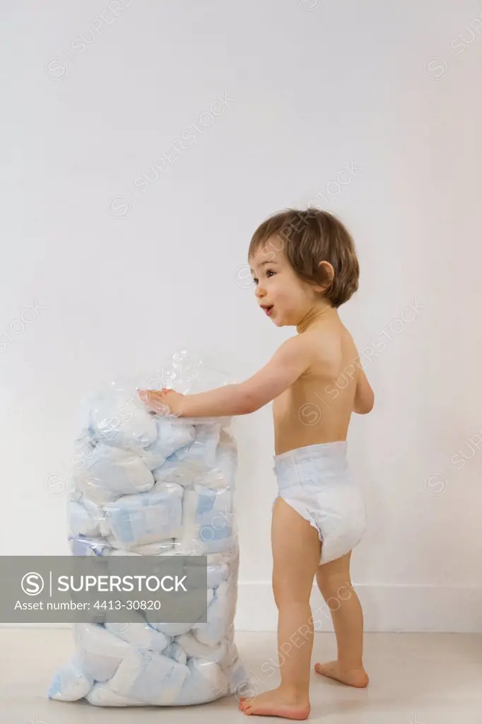 Girl before a bag containing diapers waste Studio