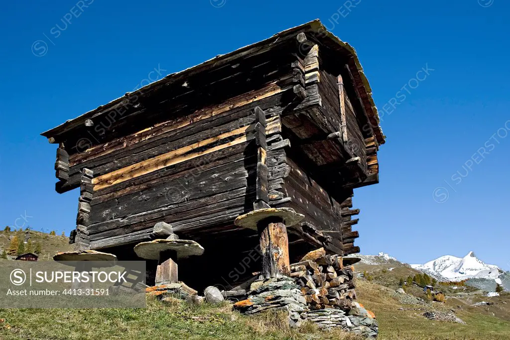 Old wooden attic of Larch perched on stones Valais