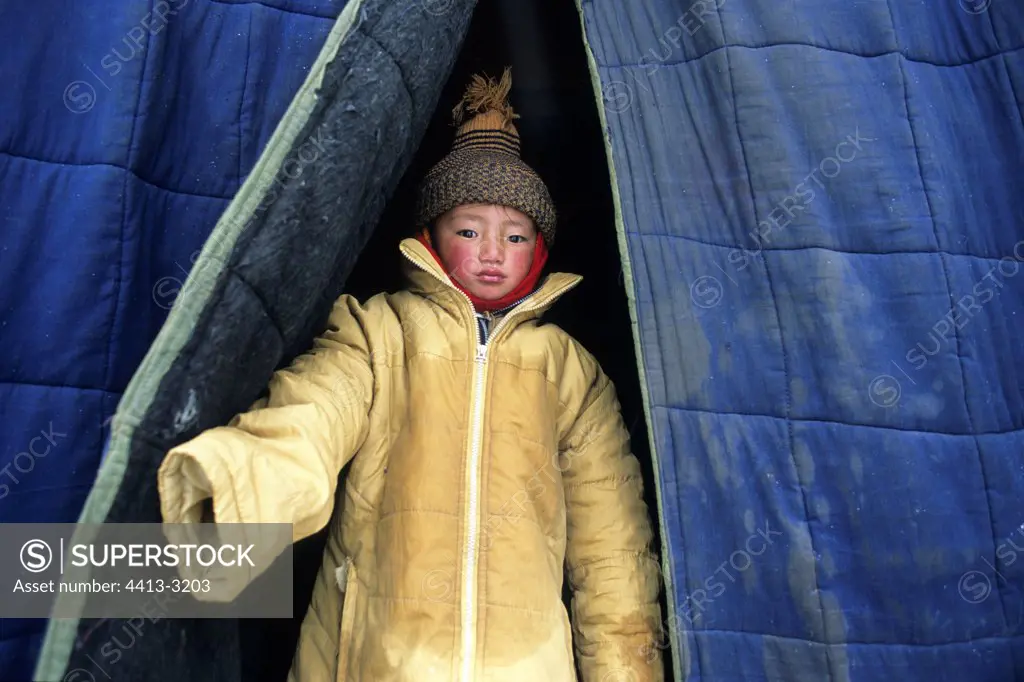 Tibetan child at the entry of a store Xiewu Kham area