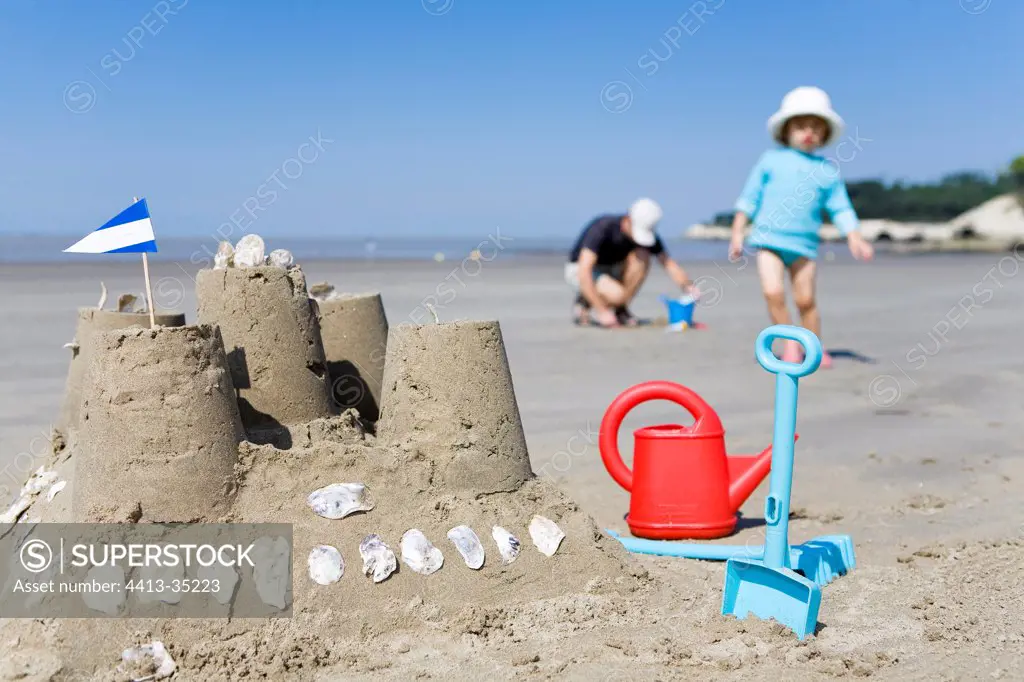Girl and sandcastle on the beach Charentes France