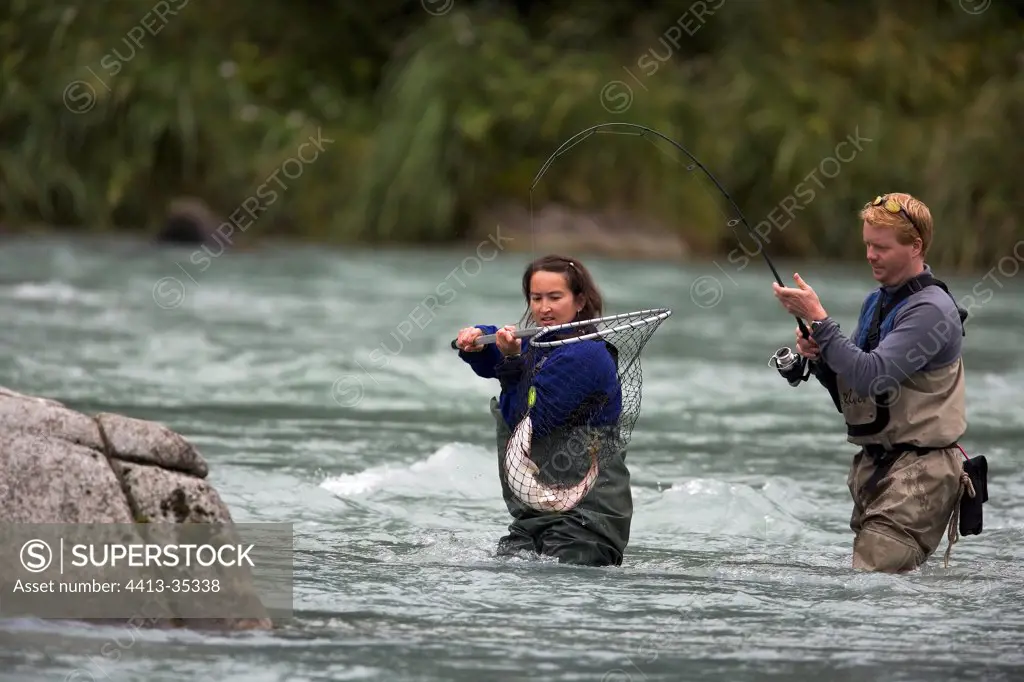 Fishermen catching a salmon in Alaska Chilkoot River