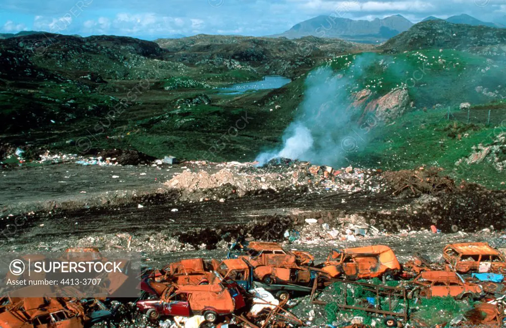 Waste and carcasses of car in an open landfill site