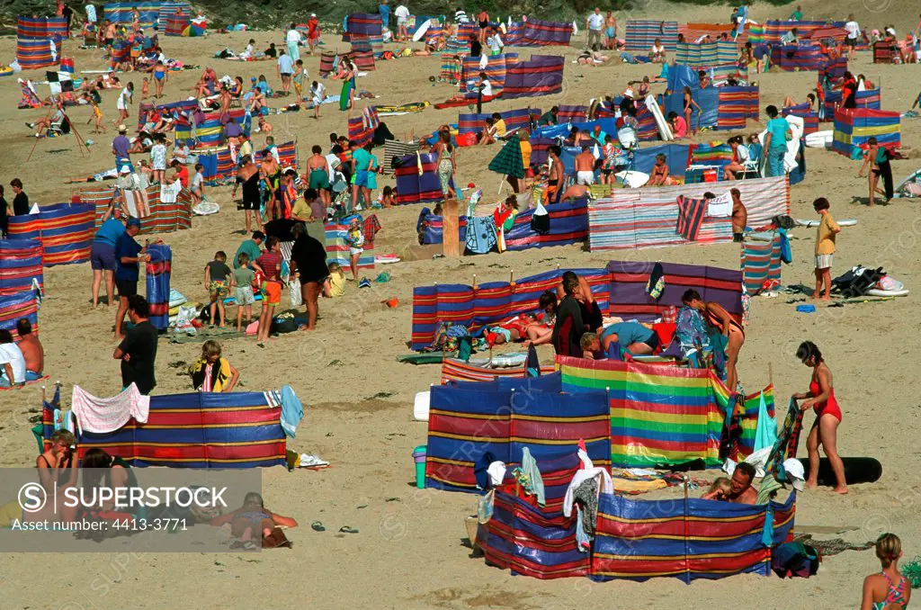 Crowds of holidaymakers on sand beach Padstow England