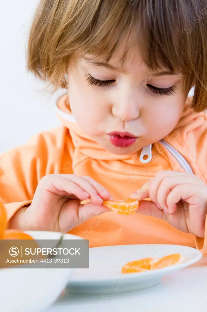 Child eating a clementine