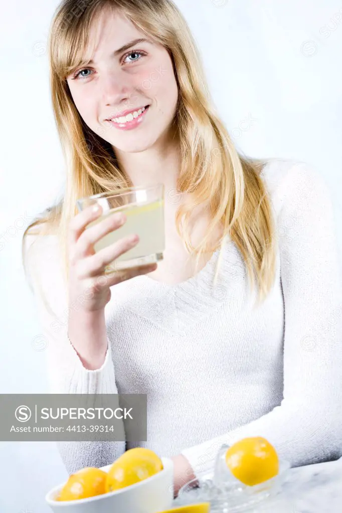 Young woman drinking a lemon juice
