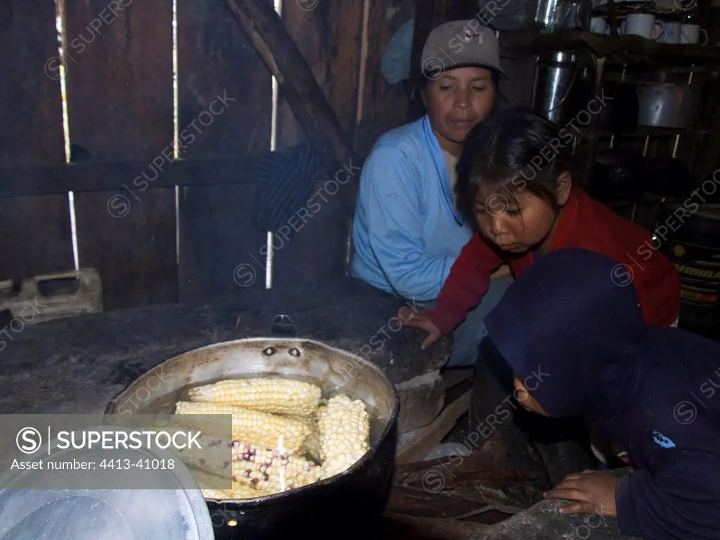 Children blowing to activate the Corn baking Imbabura