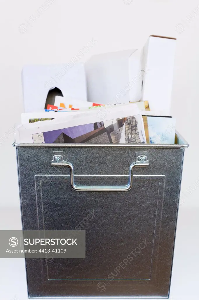 Recyclable old newspapers and used cardboard in a container