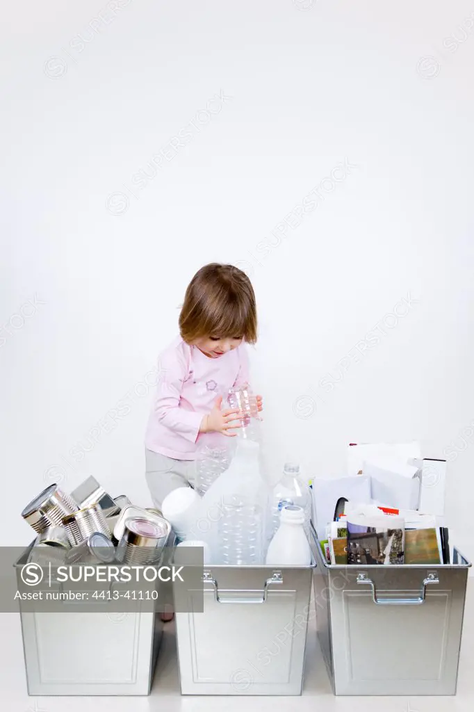 Child throwing a bottle into an adapted sorting bin