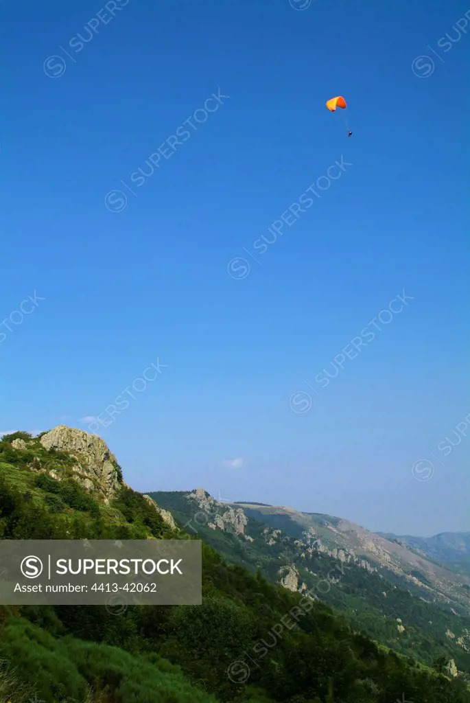 Paraglider above the Tanargue peaks Ardèche France