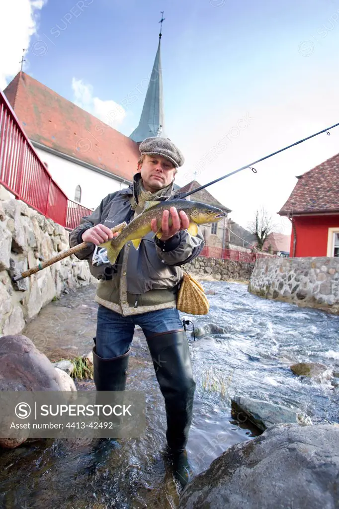 Fisherman with Brown trout in the Doller river