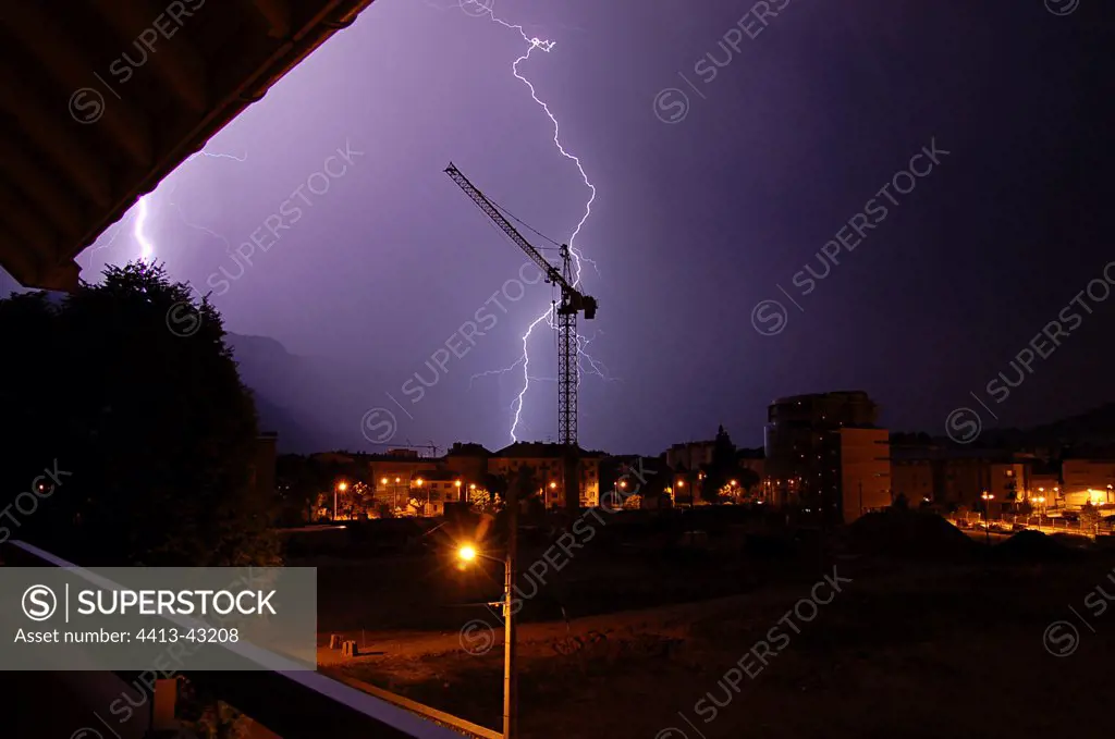 Lightnings flash on the city of Annecy during a night storm