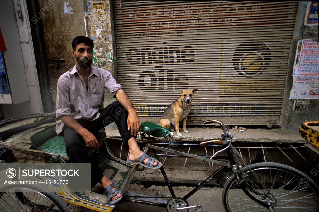 Dog and man on a scooter Vrnaçî India