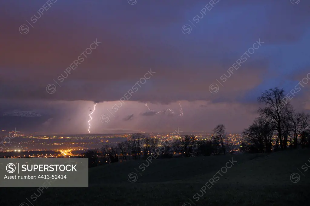 Lightning in a curtain of rain on the country of Gex France