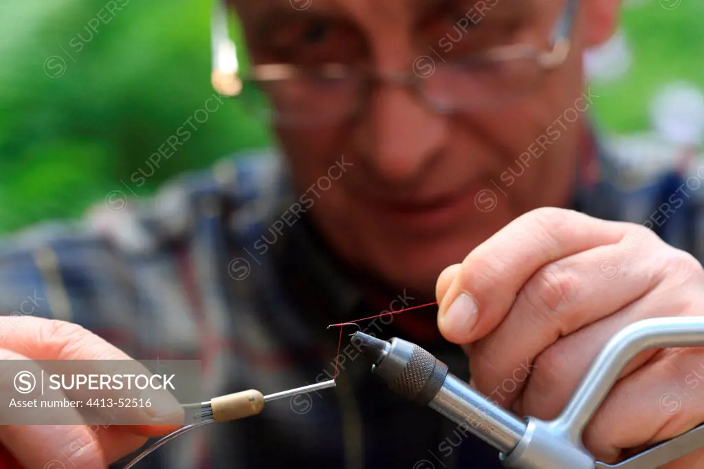 Fisherman making manually his fishing flies France
