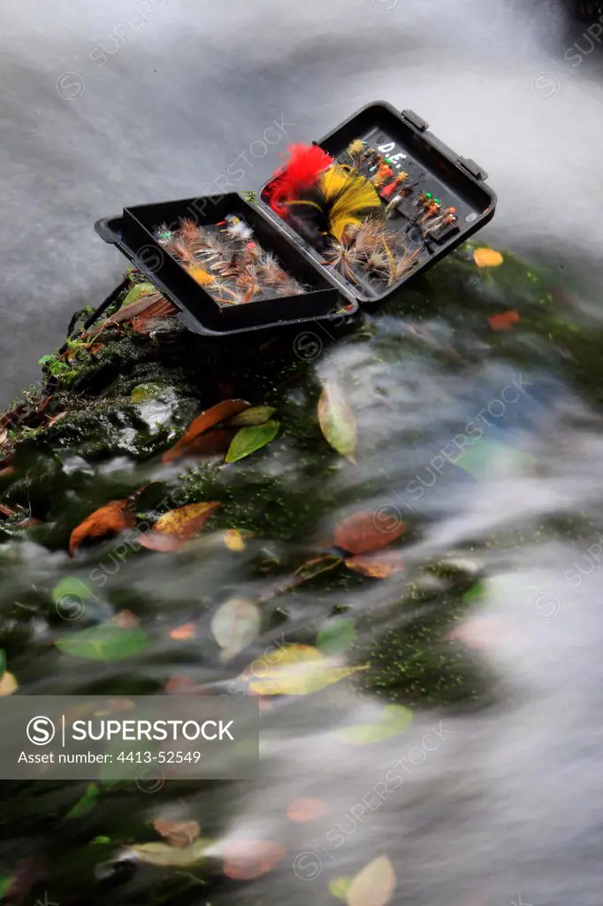 Fishing flies box on a rock in a river France