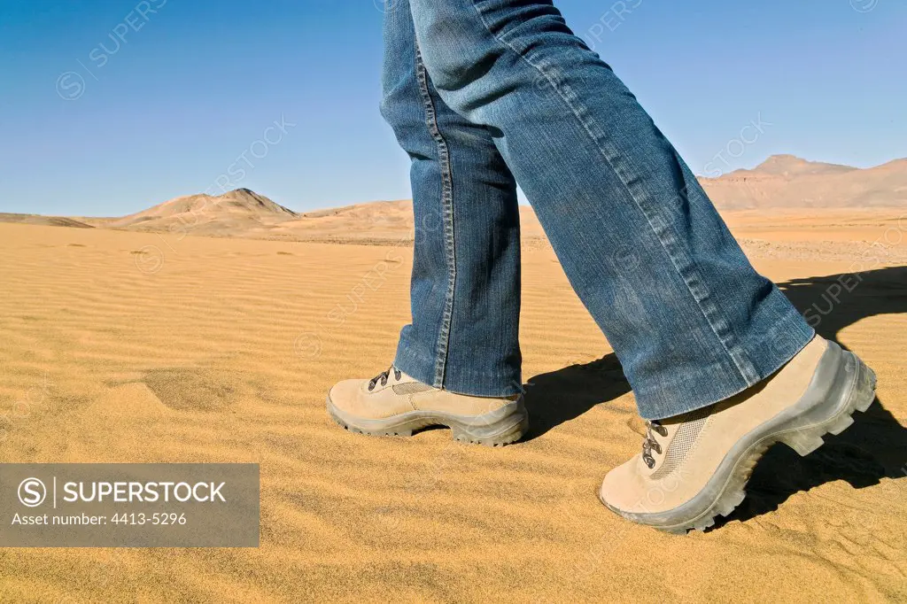 Feet going in the sand of the desert Sahara Algeria