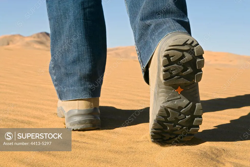 Feet going in the sand of the desert Sahara Algeria