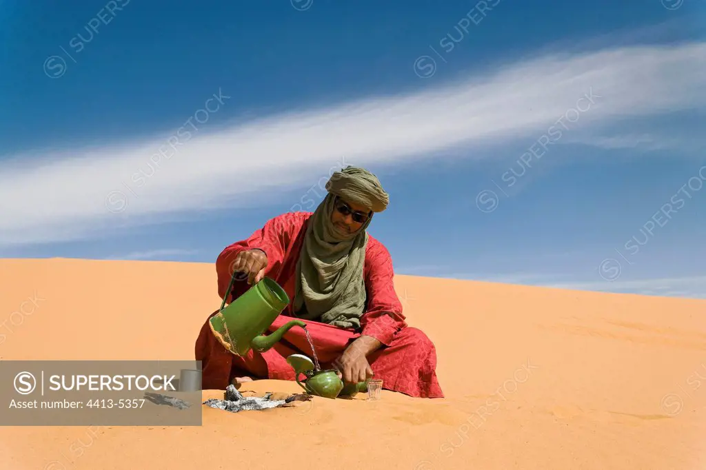 Tuareg preparing the traditional tea Gandoura Algeria