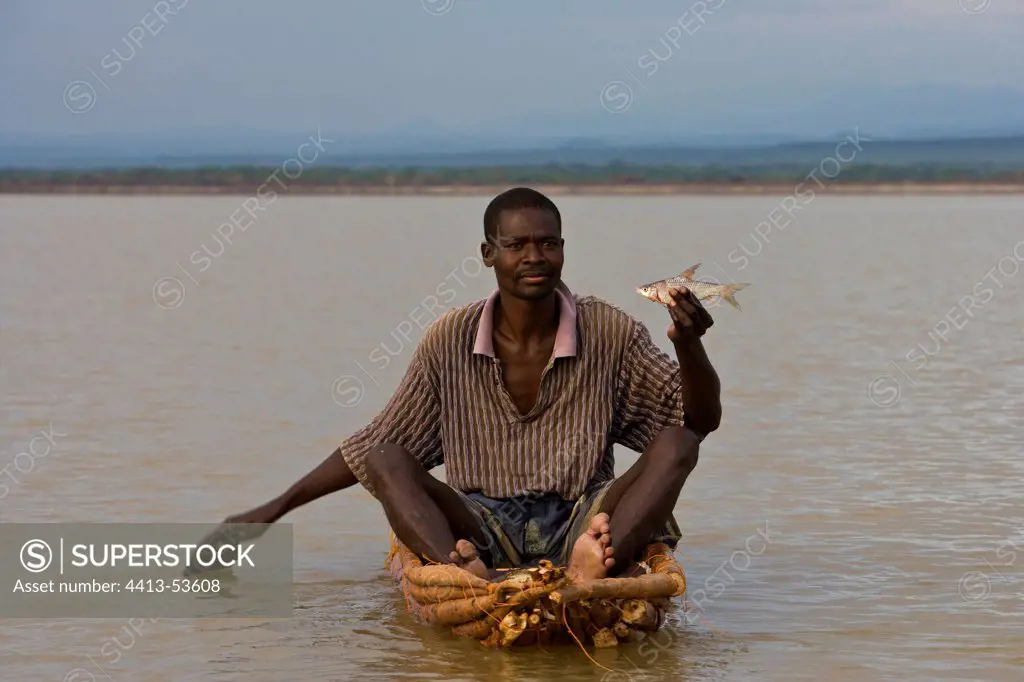 Fisherman showing a fish Lake Baringo in Kenya