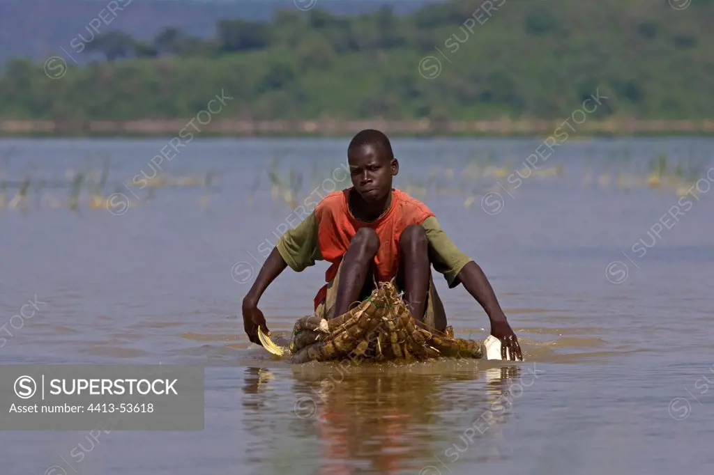 Fisherman rowing with pieces of plastic Kenya