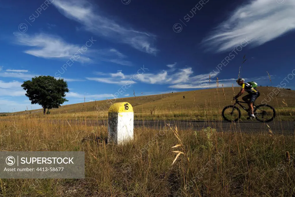 Cycling and milestone on the Causse Méjan CevennesFrance