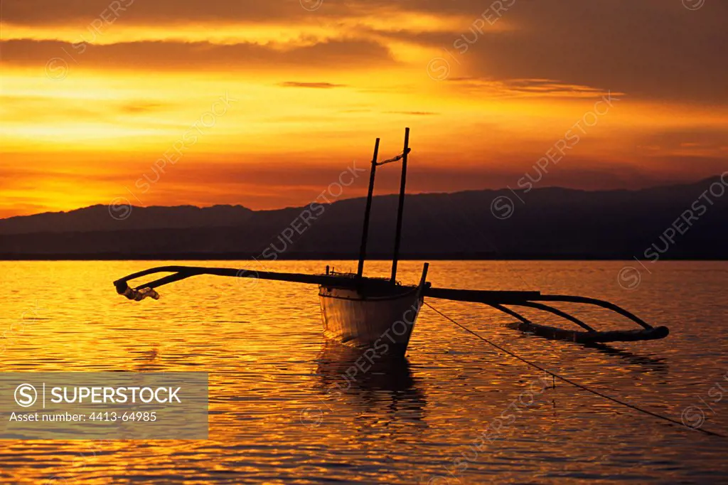 Fishing boat with pendulums at sunset Philippines
