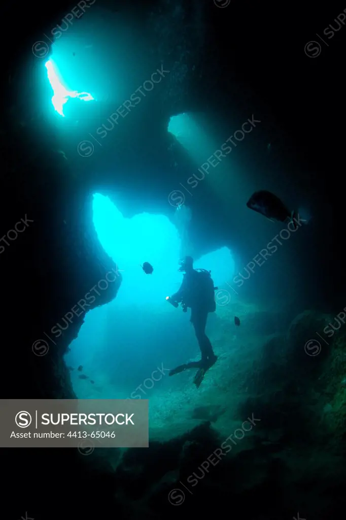Diver exploring a cave submarine Medes IslandsSpain