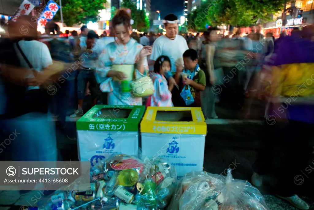 Woman in front of sorting bins in Japan