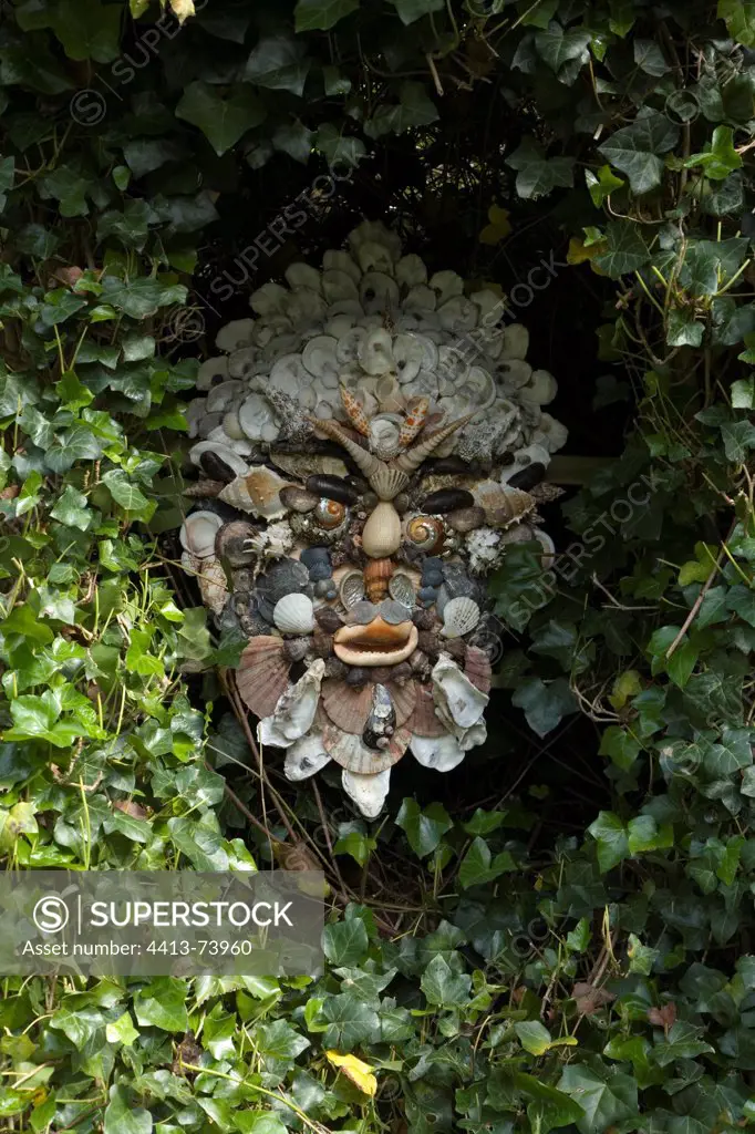 Garden decoration made with shells and ivy on a garden wall