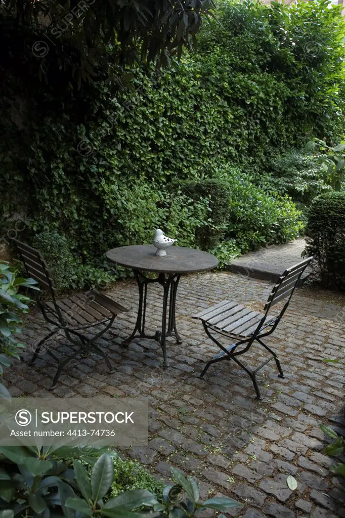 Table and chairs on an urban garden terrace