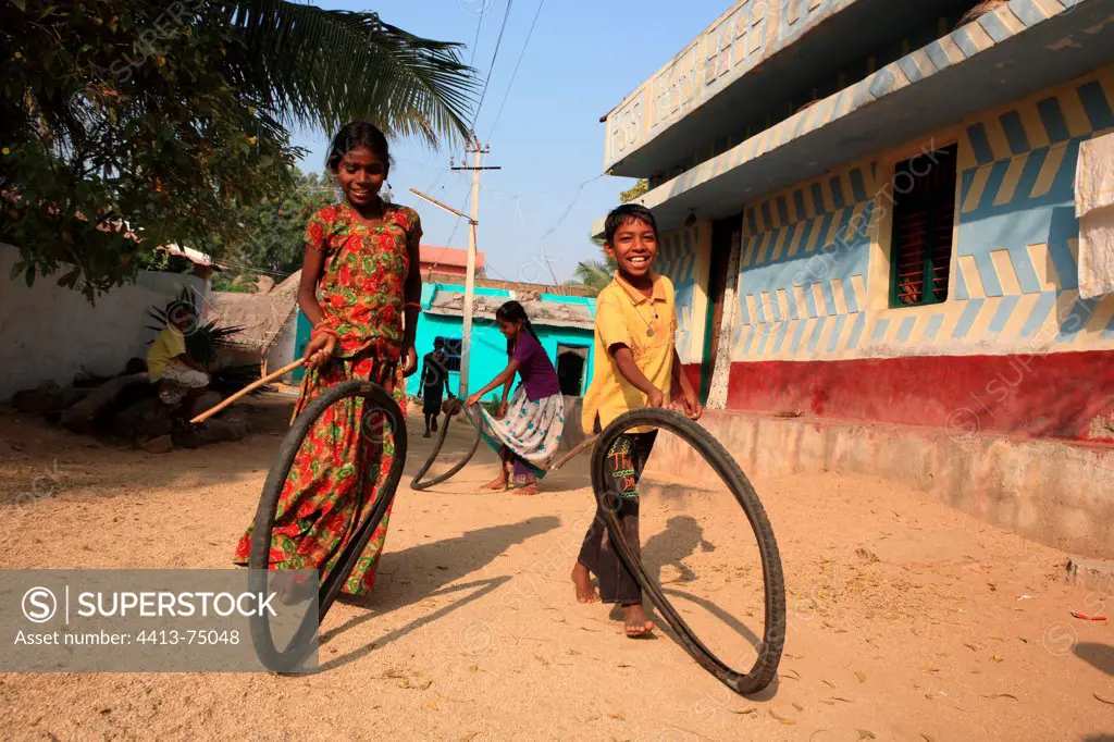 Children playing with tires Vijayanagara Hampi India