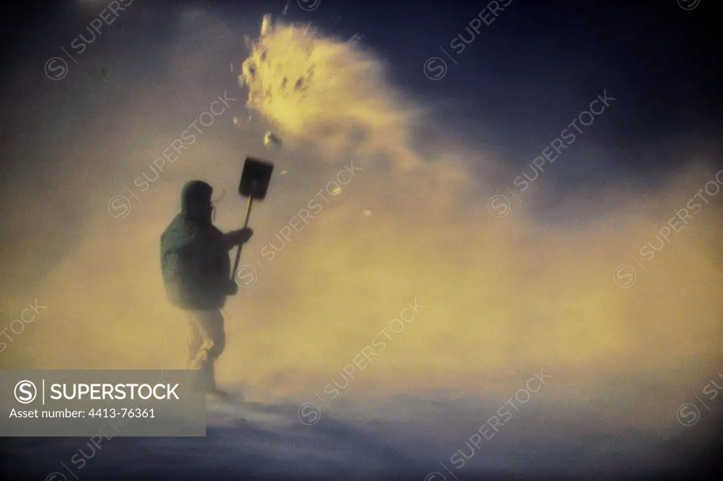 Man emerging from the snow with a shovel Greenland