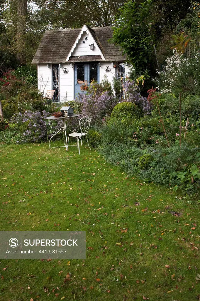 garden shed and flowerbeds in a garden in autumn