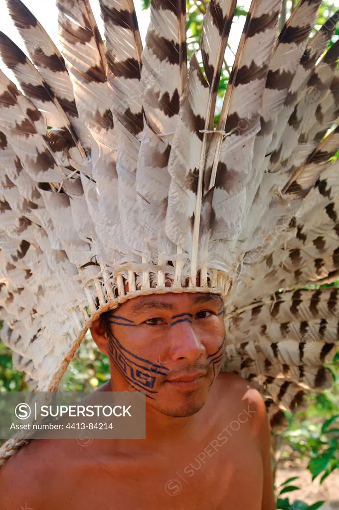 Indian wearing a traditional head-dress of eagle's feathers