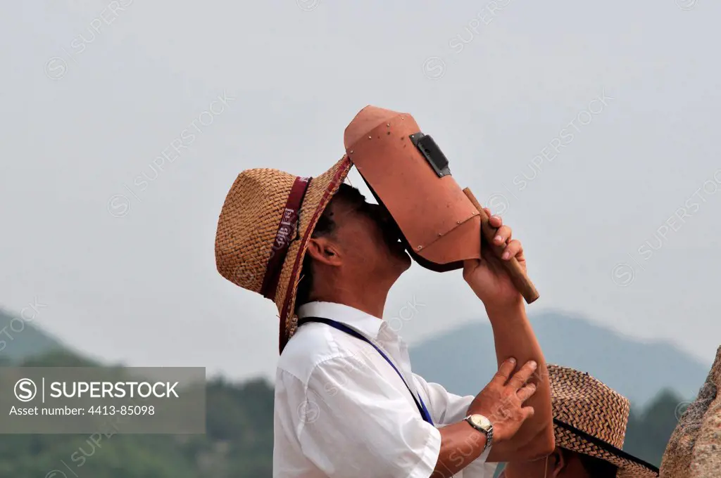 Man seeing total eclipse of the Sun China