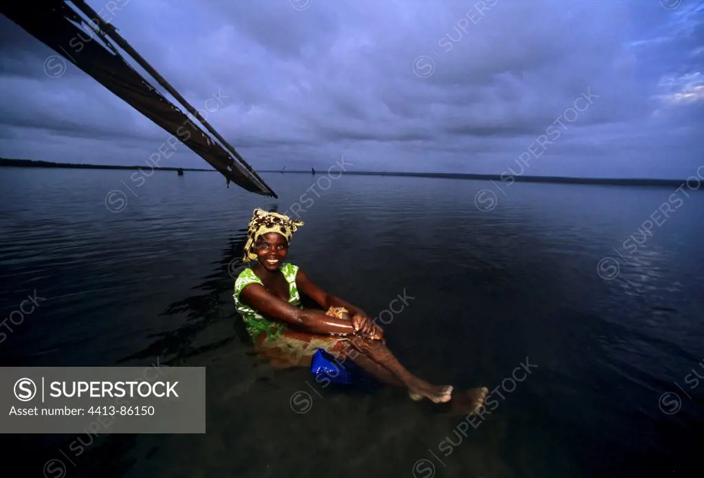 Fisherwoman relaxes after night of fishing Mozambique