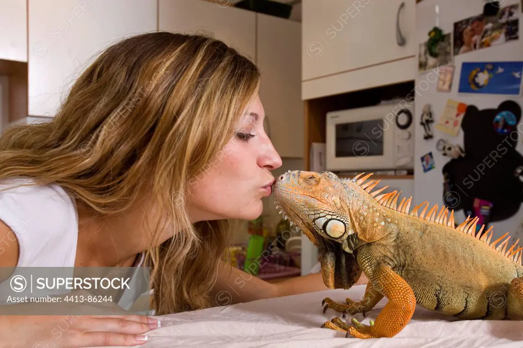 Owner of Red Iguana giving him a kiss